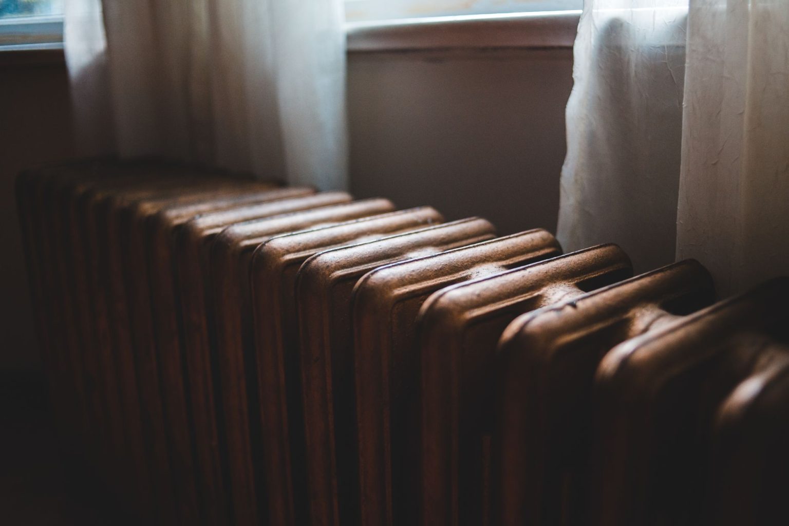 Rising Energy Bills Put Winter Heating Back in Focus for UK Households Cast iron radiator by a window as households prepare for winter heating