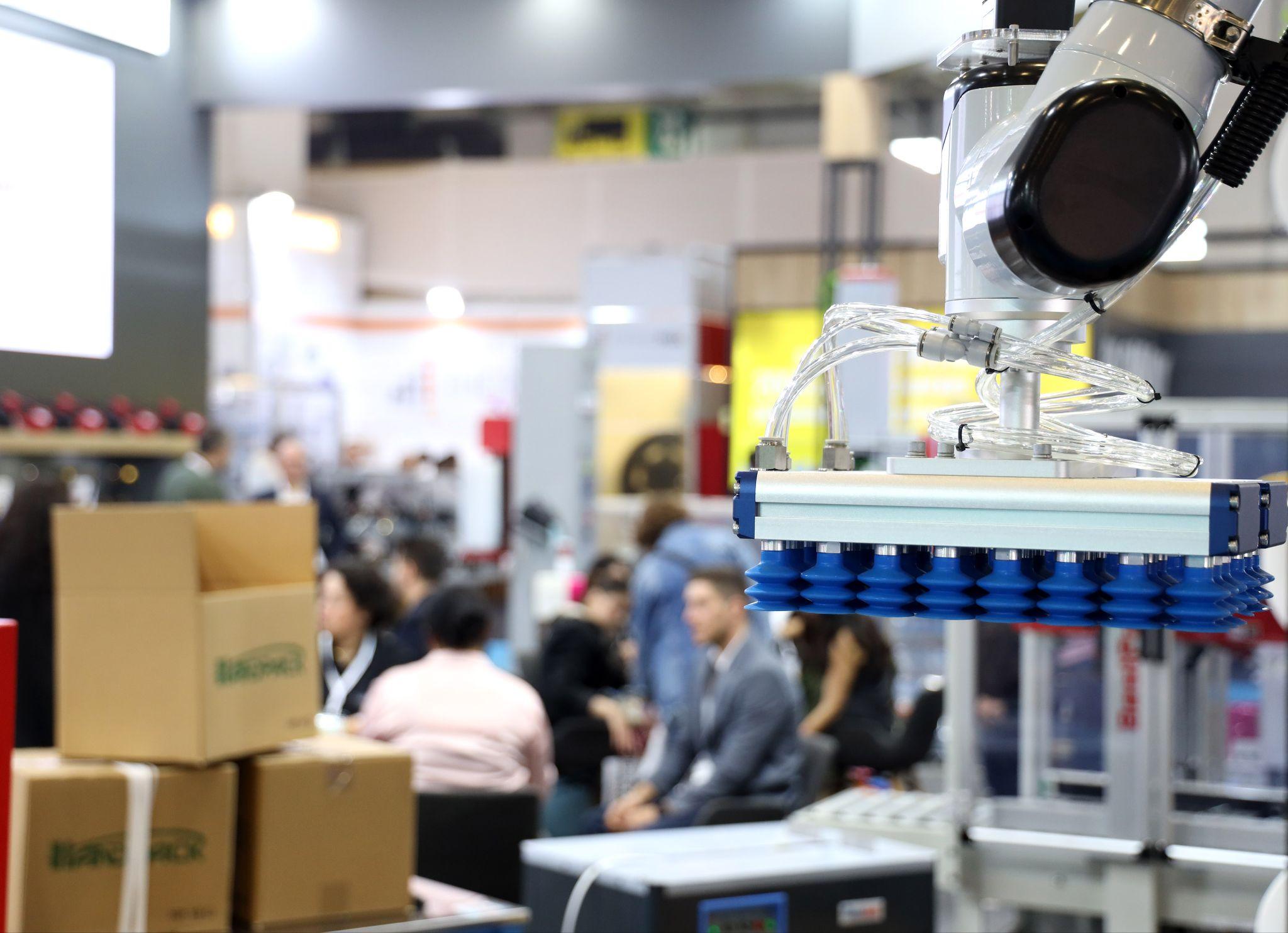 Eurasia Packaging 2026 will draw the global packaging business to Istanbul: a robotic vacuum gripper lifting cartons on an exhibitor stand at Eurasia Packaging Istanbul